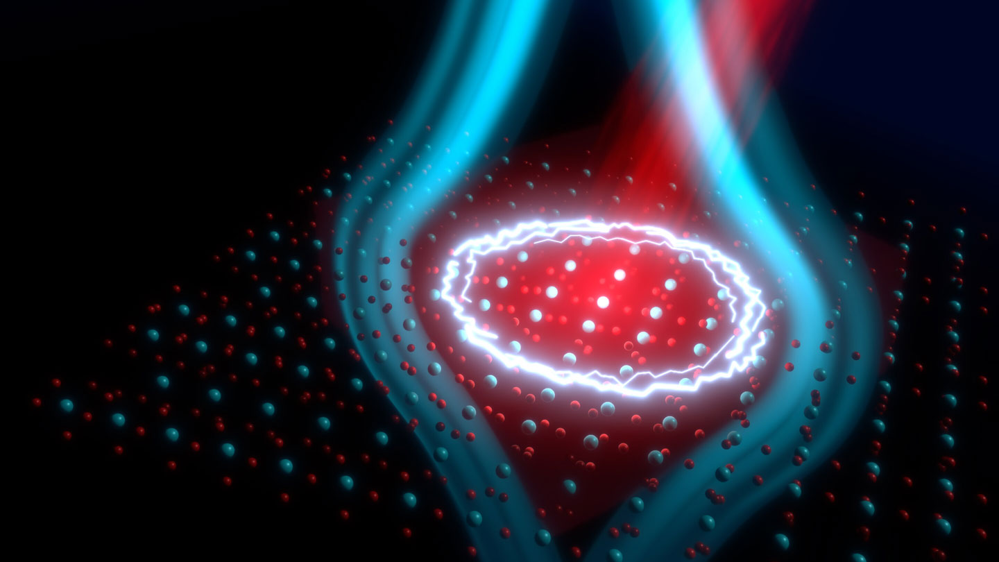 An illustration indicates a network of atoms struck with a red laser light beam. Blue lines showing a magnetic field emanate from the lit region.